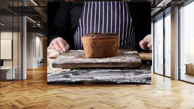 baked rye bread on a brown wooden board Wall mural