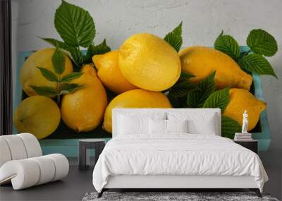 fresh ripe whole yellow lemons on a blue wooden board Wall mural