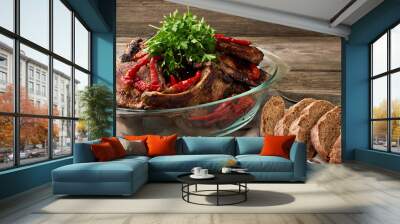 grilled pork steaks on the bone lie in a transparent glass plate on a wooden table Wall mural