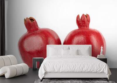 two ripe red pomegranates in a peel on a white background Wall mural