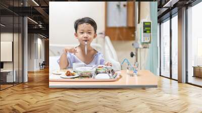 A patient boy is bored with food while he sick in the hospital. Wall mural