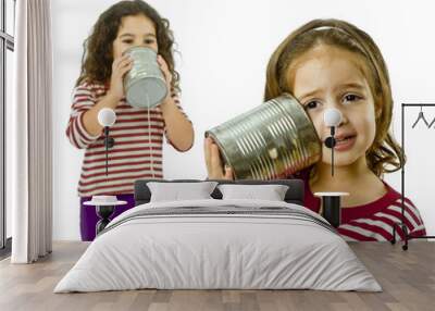 two girls talking on a tin phone isolated on white Wall mural