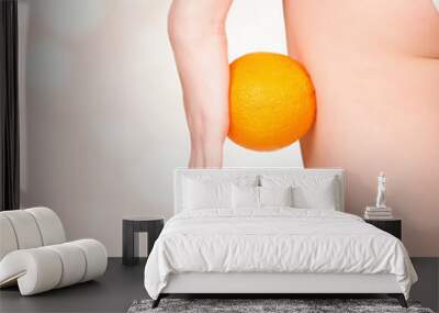 Woman with an orange, pastel blurred background Wall mural