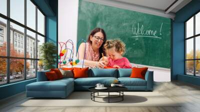 Kindergarten Teacher Supports Child on Class Wall mural