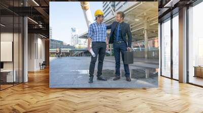 businessman worker handshaking on construction site Wall mural