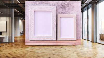 Two Picture frame on wall background and wooden table. Poster product design styled Wall mural