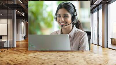 Happy call center agent wearing headset talking to client working in customer support office. Professional contract service telemarketing operator using laptop having conversation. Candid shot Wall mural