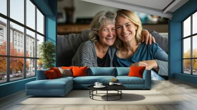 Happy loving older mature mother and grown millennial daughter laughing embracing, caring smiling young woman embracing happy senior middle aged mom having fun at home spending time together Wall mural