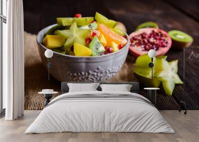 Juicy fruit salad with kiwi, mango, mandarin, carambola and pomegranate Wall mural