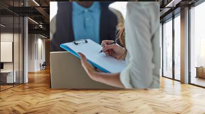 Marking her delivery as received. Cropped shot of a businesswoman signing for a package delivered by a courier to her office. Wall mural