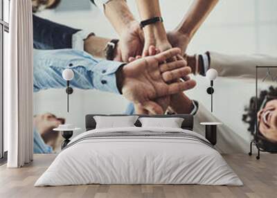 Hands stacked and piled showing team unity, strength or motivation among creative business colleagues from below. Excited, laughing and huddled group of inspired business people ready for success Wall mural