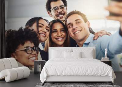 Happy, diverse and carefree colleagues taking a selfie to share on social media on their break. An excited young group of employees having fun at the office taking a picture or photo Wall mural