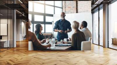 His presentation is motivating. Shot of a businessman giving a presentation to his colleagues in a boardroom. Wall mural