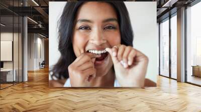 Making the health of my teeth a priority. Portrait of an attractive and happy young woman flossing her teeth. Wall mural