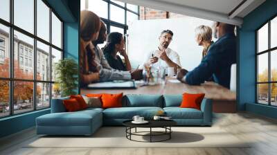 Our meetings are always productive. Shot of a businessman leading a meeting in the boardroom. Wall mural