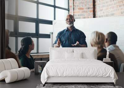 Senior business man doing presentation, planning and talking in a meeting, seminar or training workshop in a boardroom. Manager sharing ideas, teaching and coaching new employees during conference Wall mural