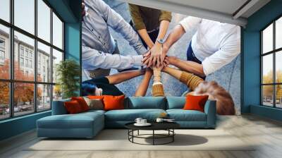 Teamwork, hands in a huddle and working together with a team or group of business people and colleagues standing in the office. Togetherness, unity and motivation between creative coworkers at work Wall mural