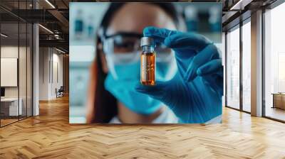 Scientist Holding a Vial of Liquid in a Laboratory Wall mural