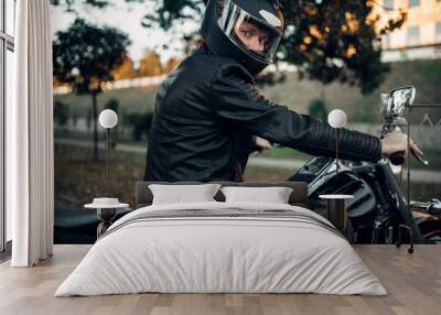 Biker in helmet poses on classical chopper Wall mural