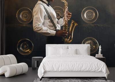 Black jazzman in hat plays the saxophone on stage Wall mural