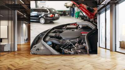 Car with opened hood in automobile service Wall mural