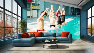 Children jumping into sport swimming pool Wall mural