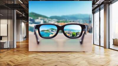 cityscape focused in glasses lenses Wall mural