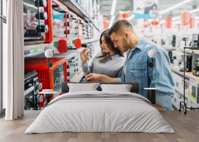 couple buys an electric oven in a supermarket Wall mural