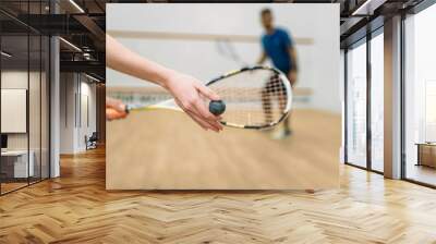 Couple play squash game in indoor training club Wall mural