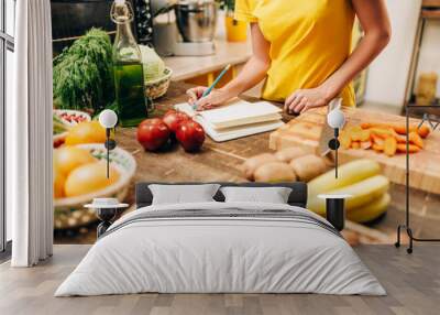 Female person cooking on the kitchen, bio food Wall mural