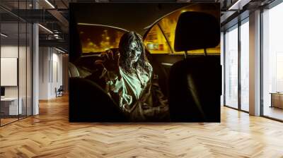 Horror zombie woman with bloody face in the car Wall mural