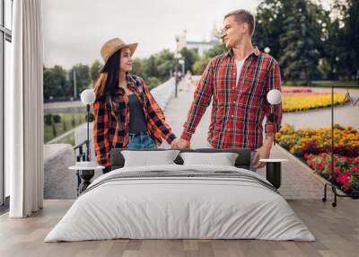 Love couple of tourists holding hands Wall mural