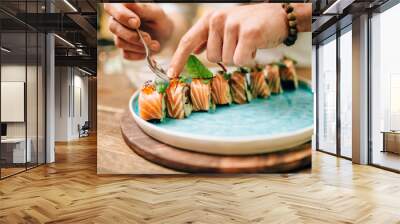 Male chef cooking sushi rolls, japanese food Wall mural