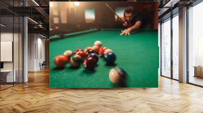 Man hits a pyramid in billiards. Wall mural