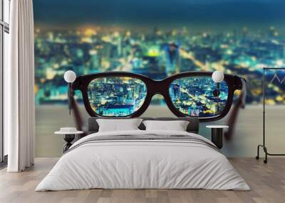 Night cityscape focused in glasses lenses Wall mural