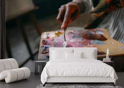 Painter holds brush and colorful paints on palette Wall mural