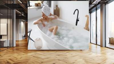 Portrait of gorgeous woman in towel on head taking bath Wall mural