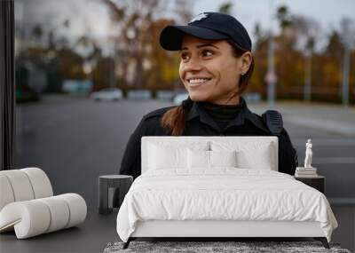 Portrait of smiling police woman on street Wall mural