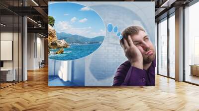 Sad man dreaming about vacation Wall mural