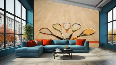 Squash rackets and ball on court floor, nobody Wall mural