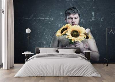 Studio shoot of man with bouquet  sunflowers Wall mural