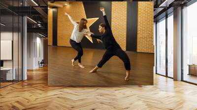 Two contemporary dance performers poses in studio Wall mural