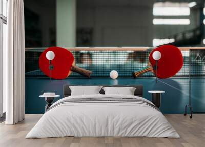 Two tennis rackets and ball against net on table Wall mural