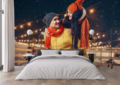 Winter evening, love couple having fun outdoors Wall mural