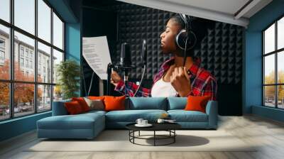 Young woman songs in audio recording studio Wall mural