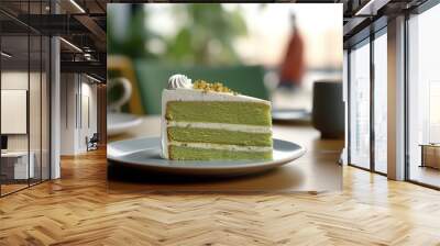  slice of green matcha cream cake on plate, table, indoor cafe  Wall mural