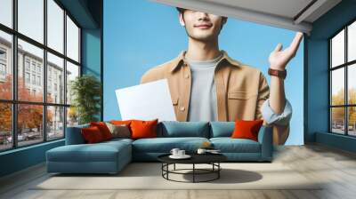 image of a man wearing casual attire showcasing a document with his right hand, man holding a paper  Wall mural