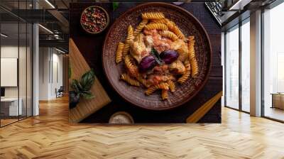 a delicious plate of pasta, likely fusilli, mixed with what appears to be pieces of chicken in a creamy sauce. Wall mural