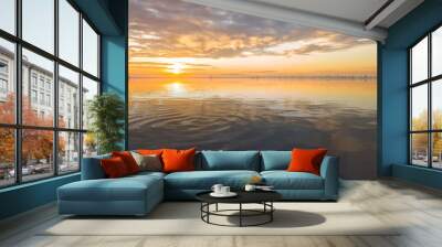 Beautiful sunrise over sea with reflection in water. Wall mural