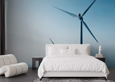 An engineer is seen climbing tower of wind turbine, showcasing dedication and skill Wall mural